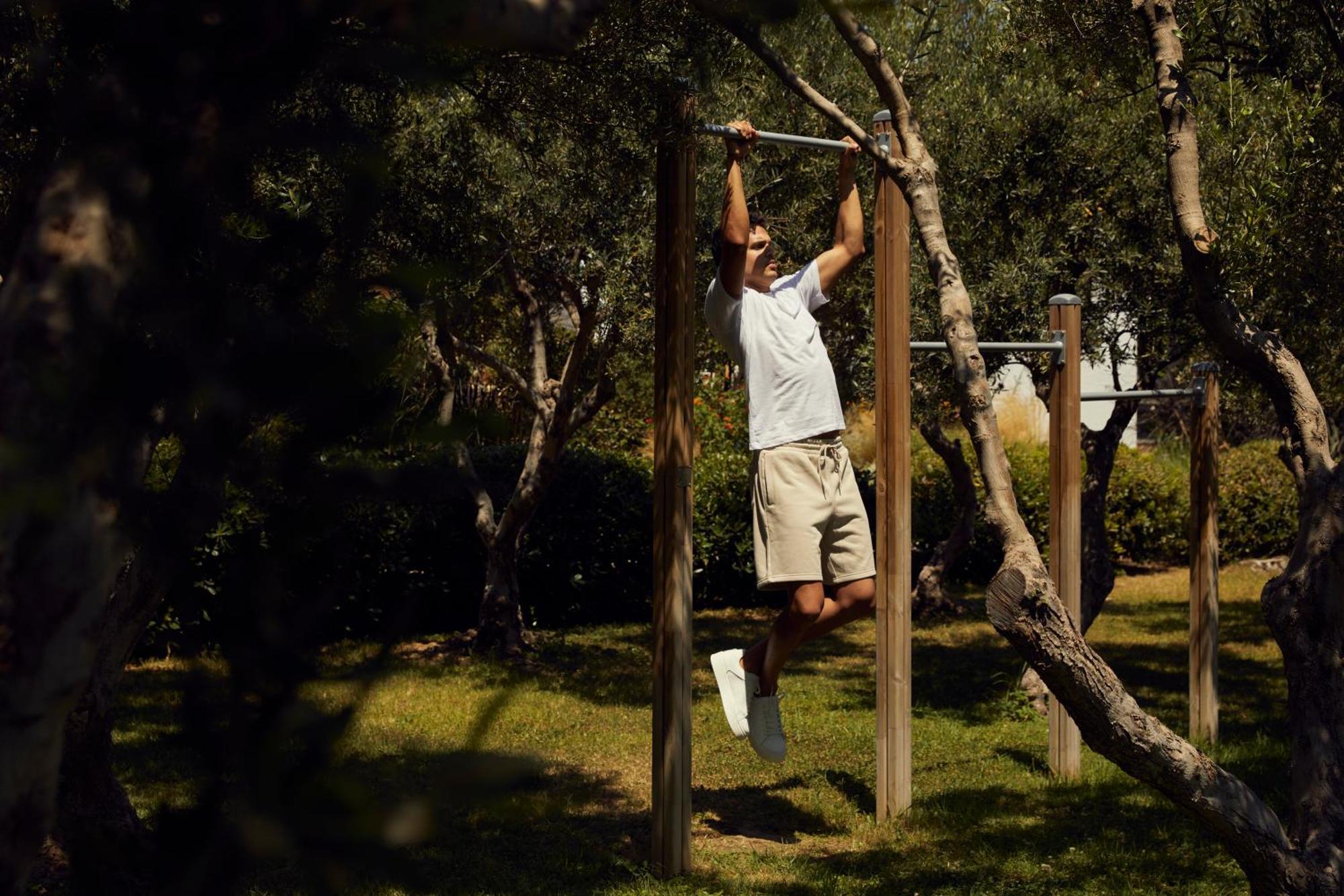 Minos Palace Resort - Adults Only Ágios Nikólaos Екстериор снимка A man doing pull-ups on a horizontal bar